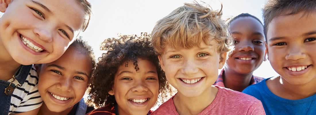 group of kids huddled together smiling